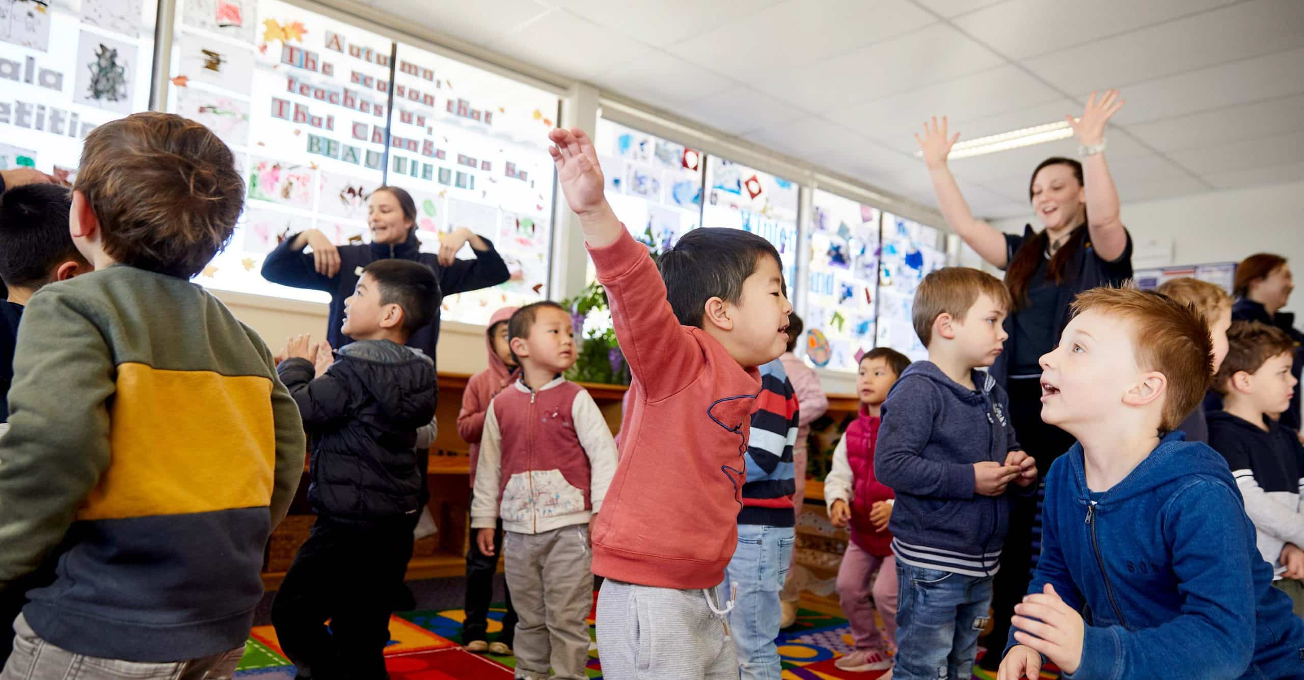 Children dance joyously during Calendar Time at Kindalin Castle HIll